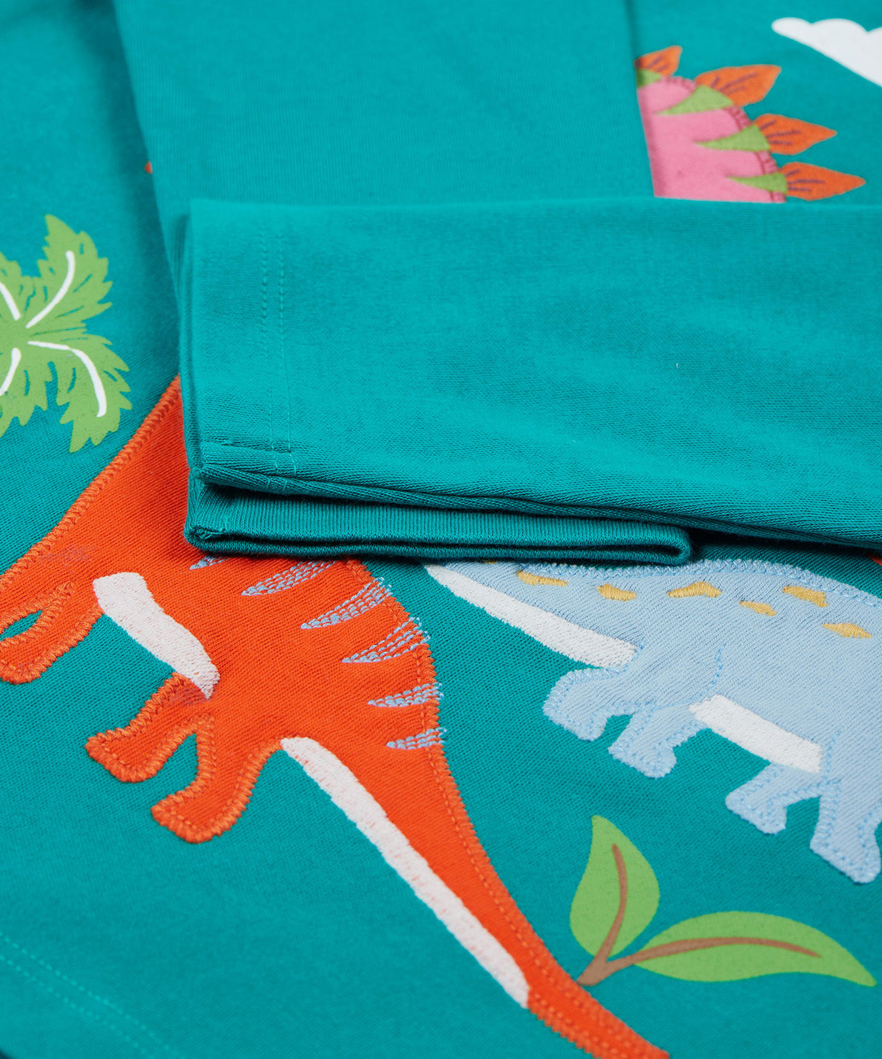 Frugi green adventure long sleeve top dinosaur cuff detail