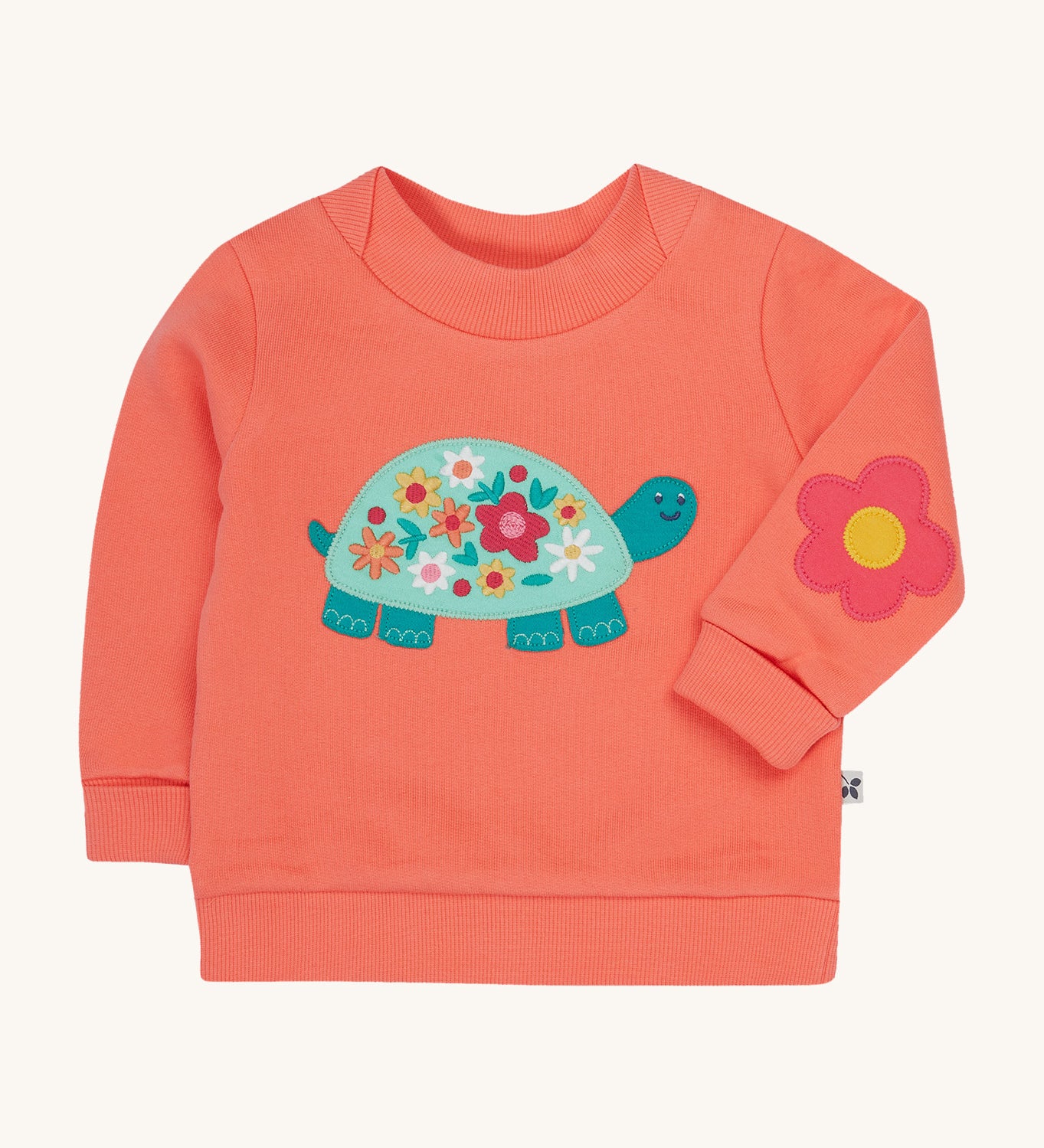 Frugi pink easy on jumper tortoise design on a cream background.