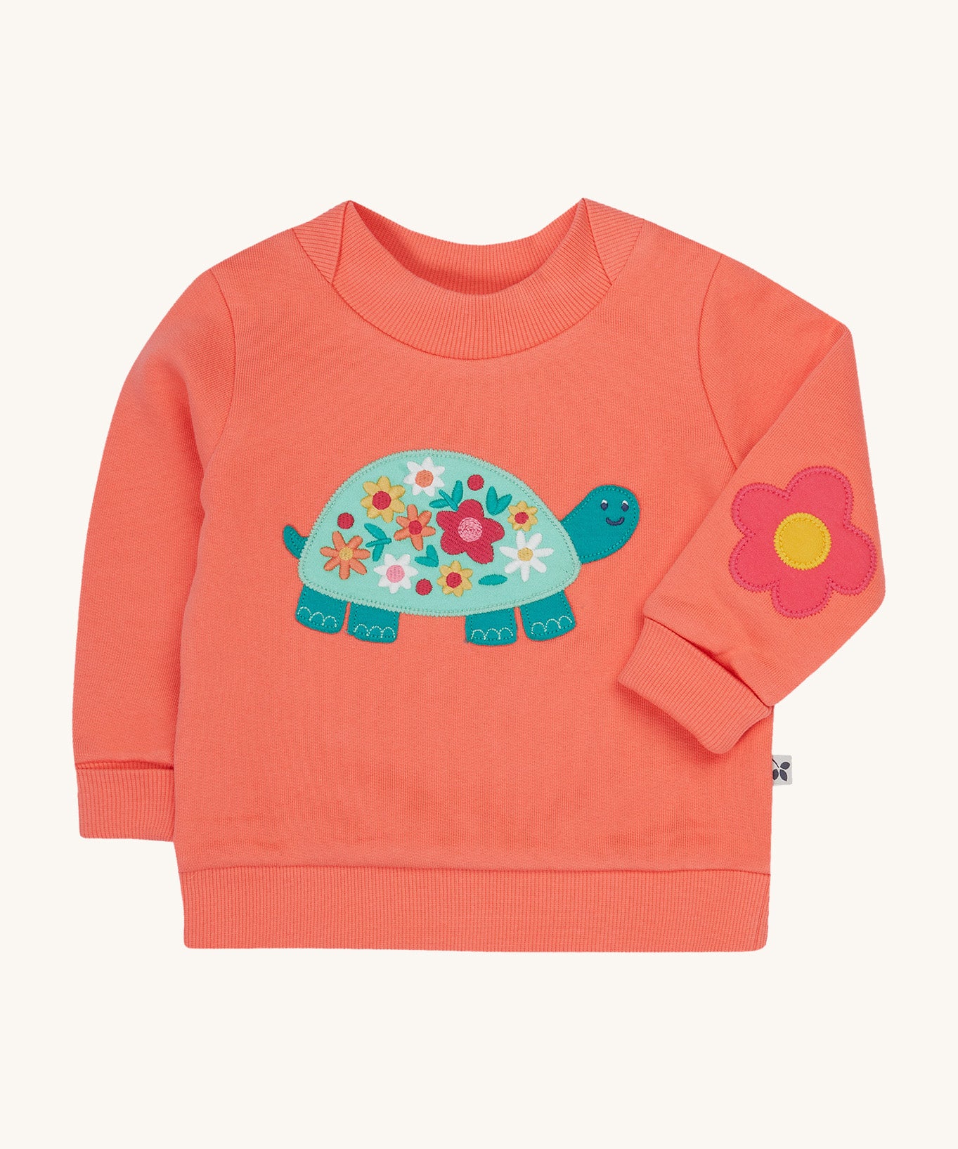 Frugi pink easy on jumper tortoise design on a cream background.