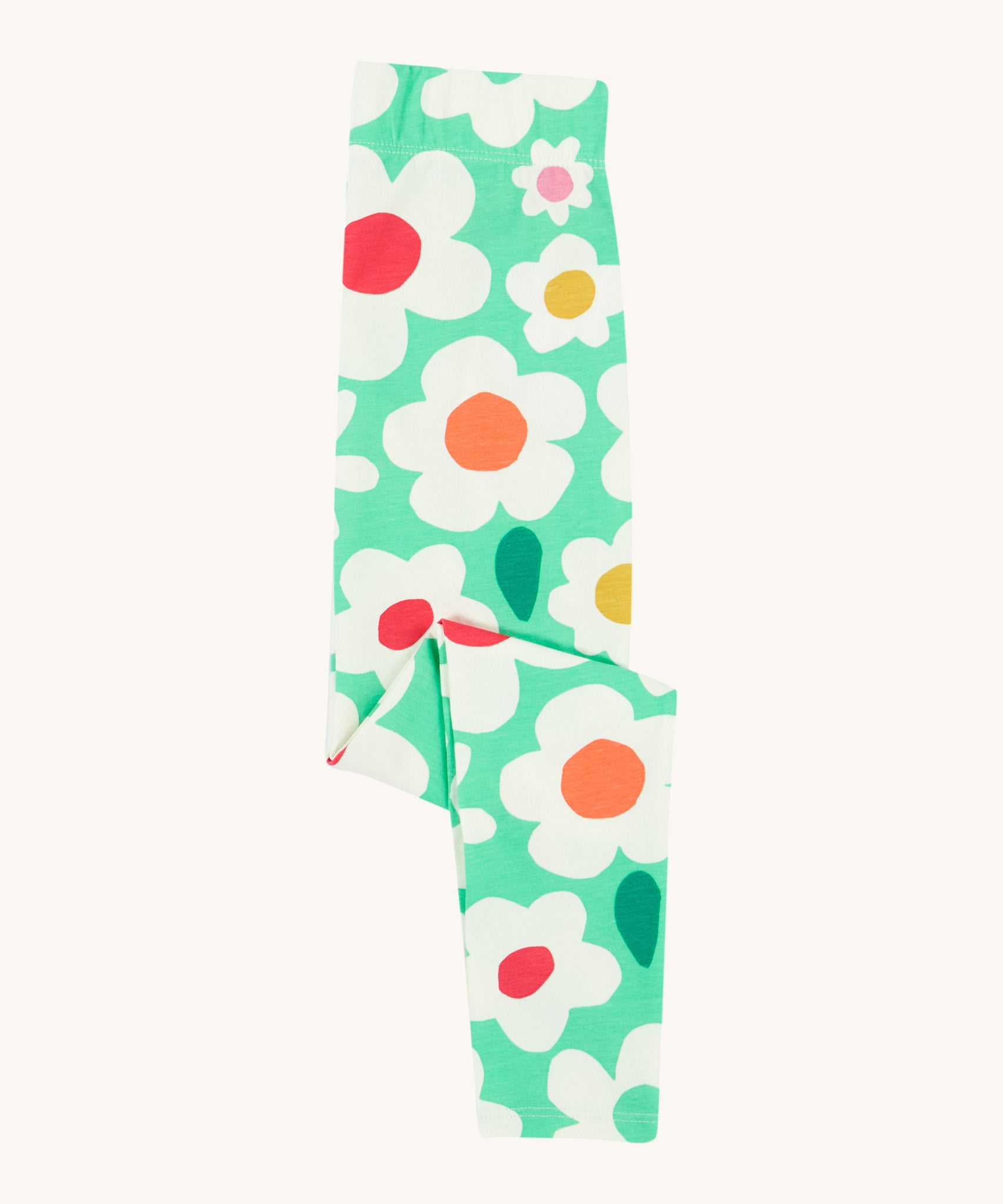 Frugi green leggings daisy design folded on a cream background.