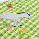 Close up of the Frugi little kids green gingham, donkey myrtle body dress - showing a grey donkey appliqué on green and white gingham organic cotton fabric