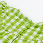 Close up of the Frugi little kids green gingham, donkey myrtle body dress - showing the back popper fastener detail on green and white gingham organic cotton fabric