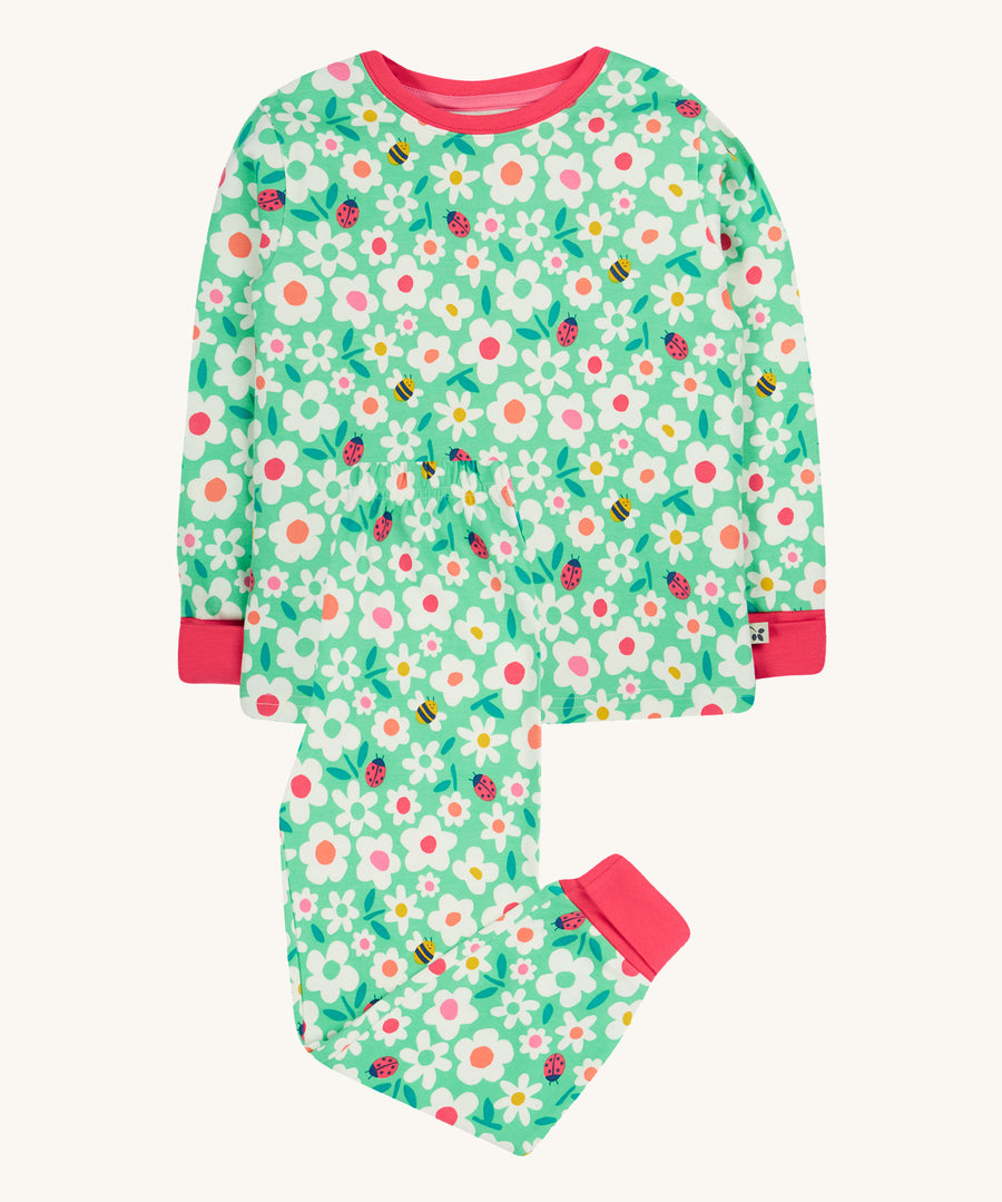 Frugi green pyjamas set busy bugs design on a cream background.