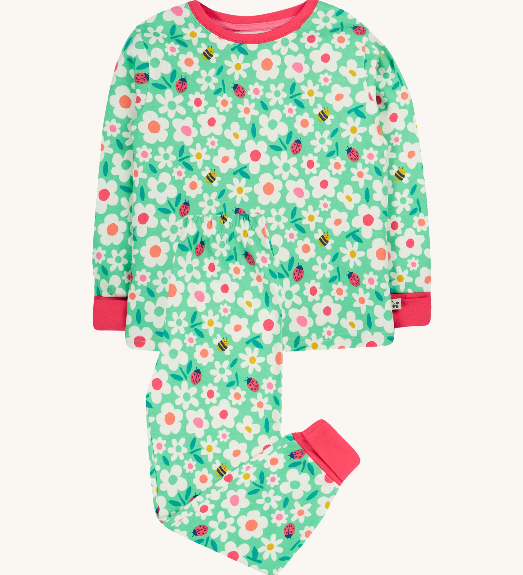 Frugi green pyjamas set busy bugs design on a cream background.