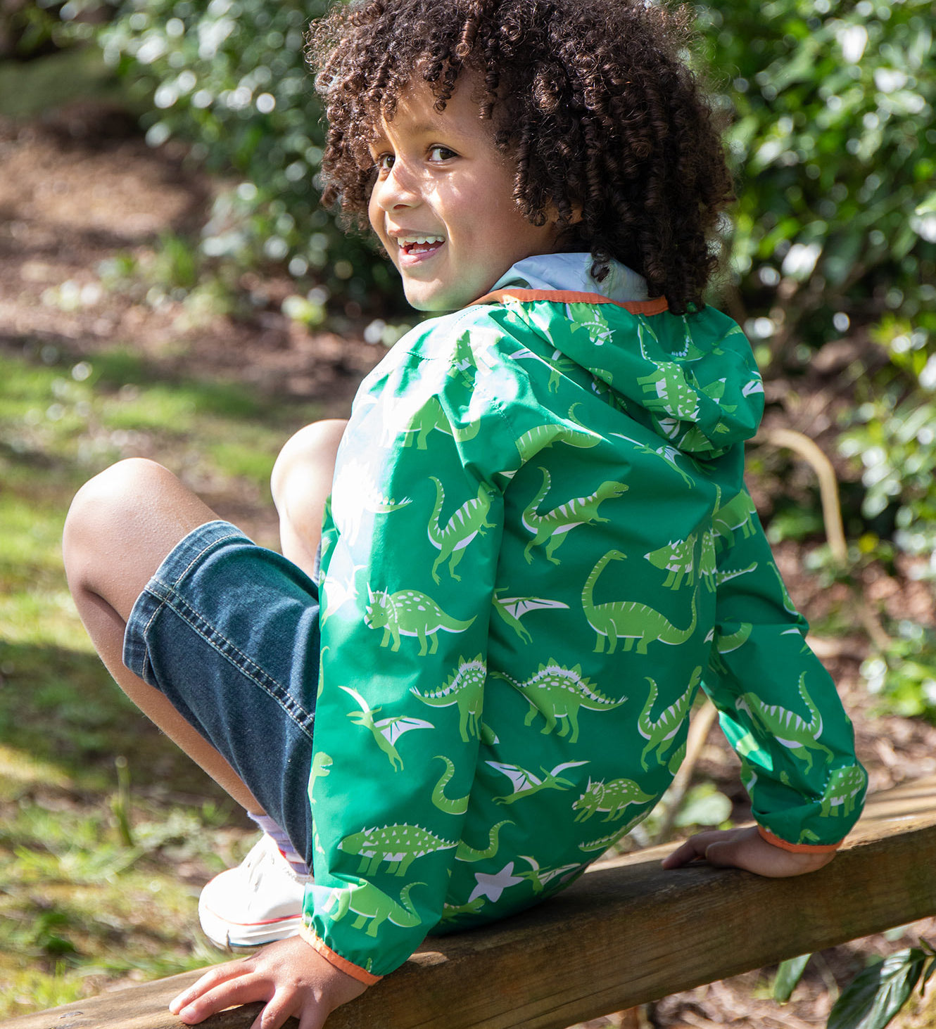 Frugi green rain jacket dino roar design