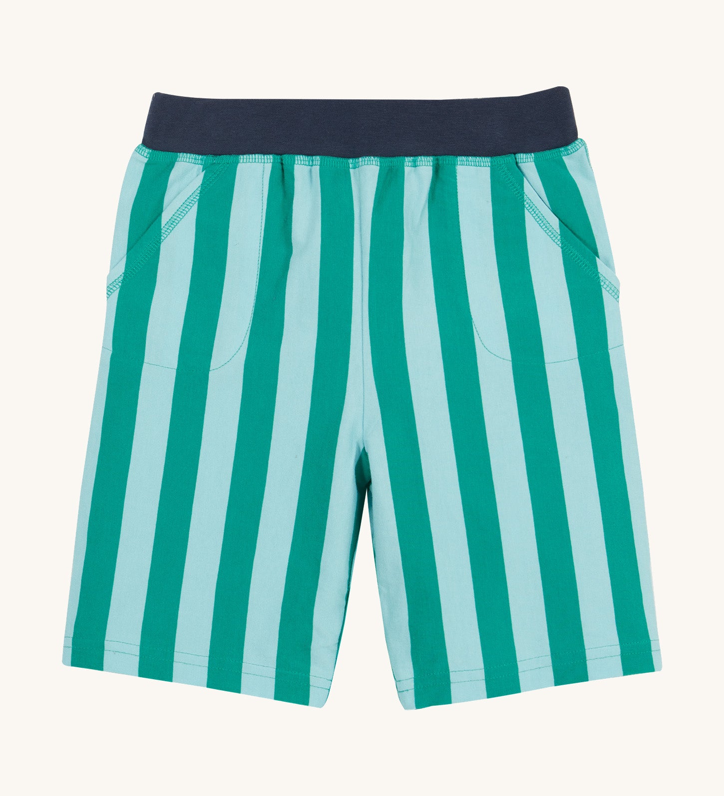 Frugi shorts in green stripes on a cream background.