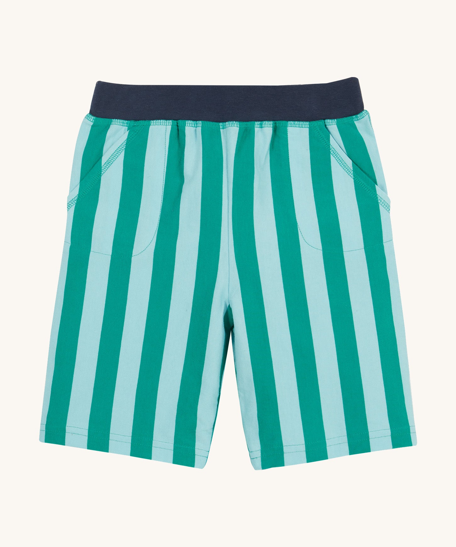 Frugi shorts in green stripes on a cream background.