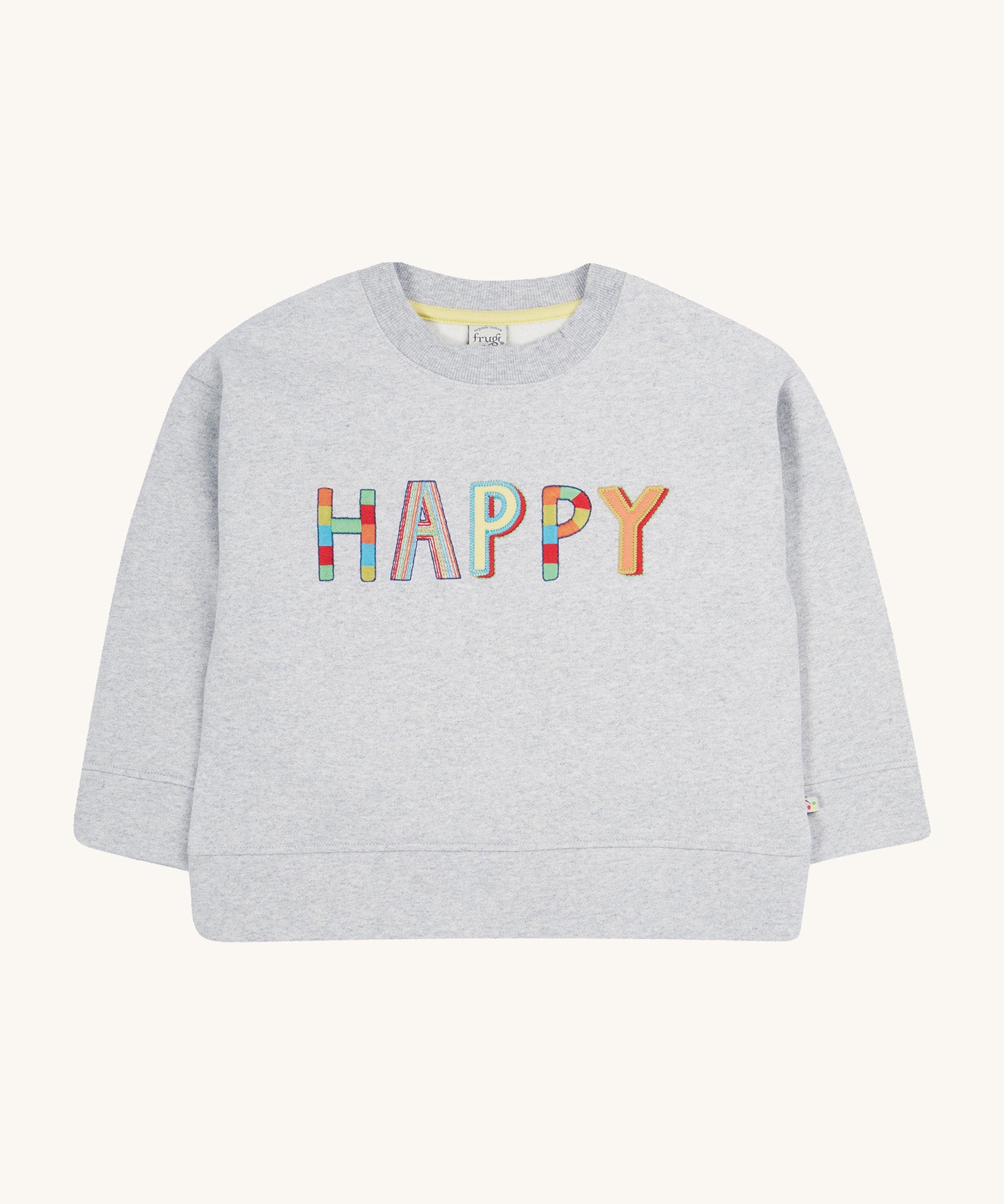 Frugi grey oversized sweater happy design on a cream background.