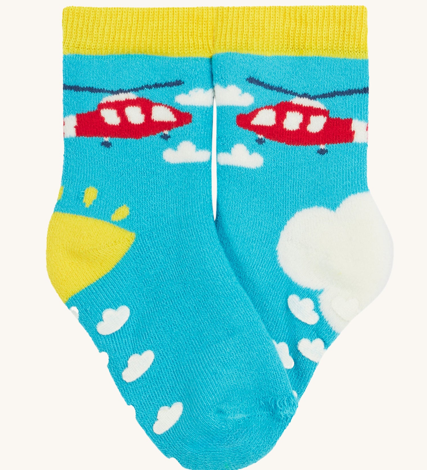 Frugi 2 pack grippy socks helicopter design on a cream background.