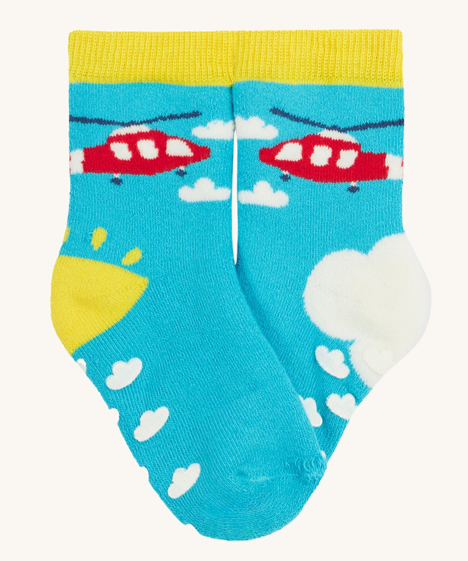 Frugi 2 pack grippy socks helicopter design on a cream background.