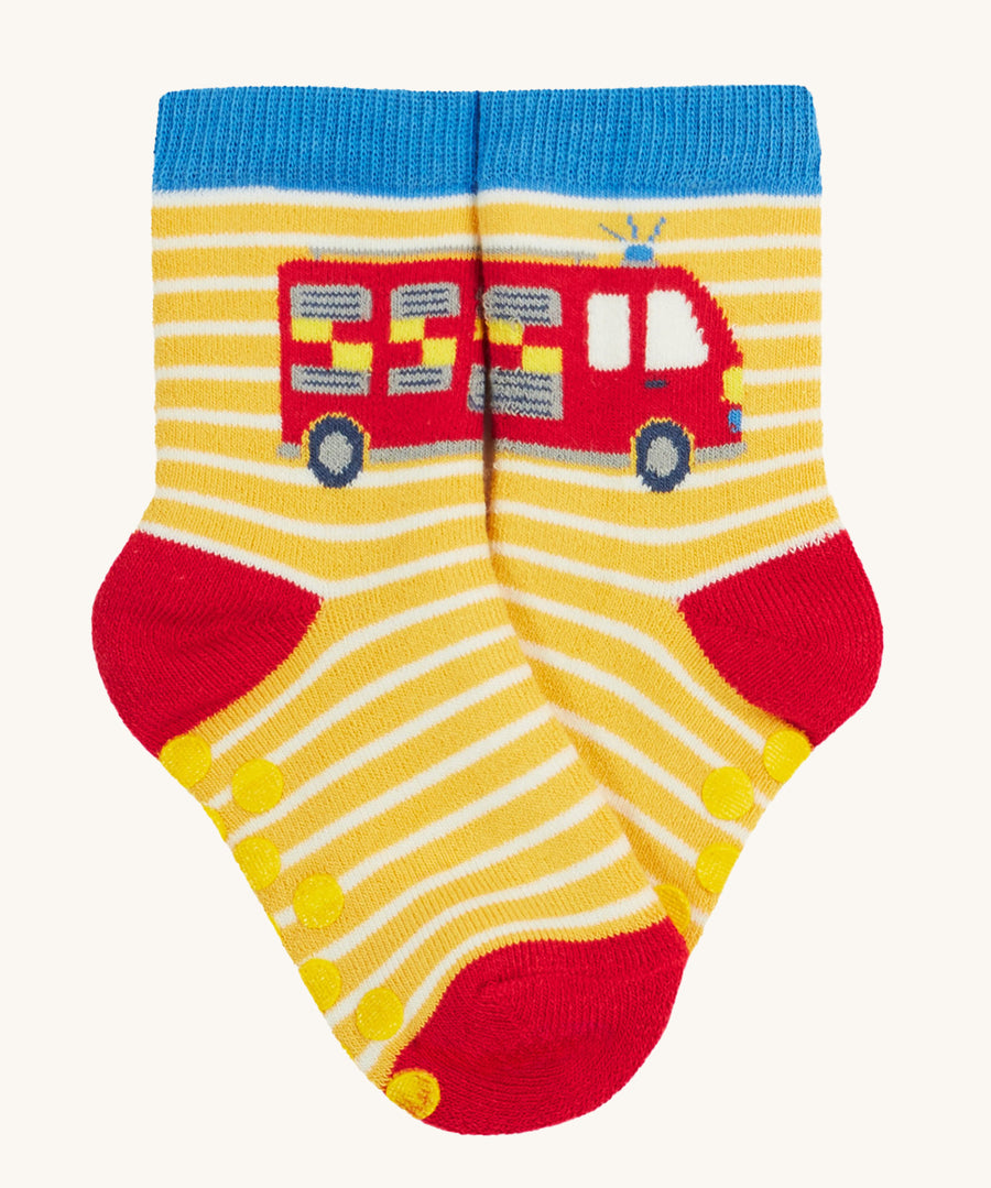 Frugi 2 pack grippy socks fire engine design on a cream background.