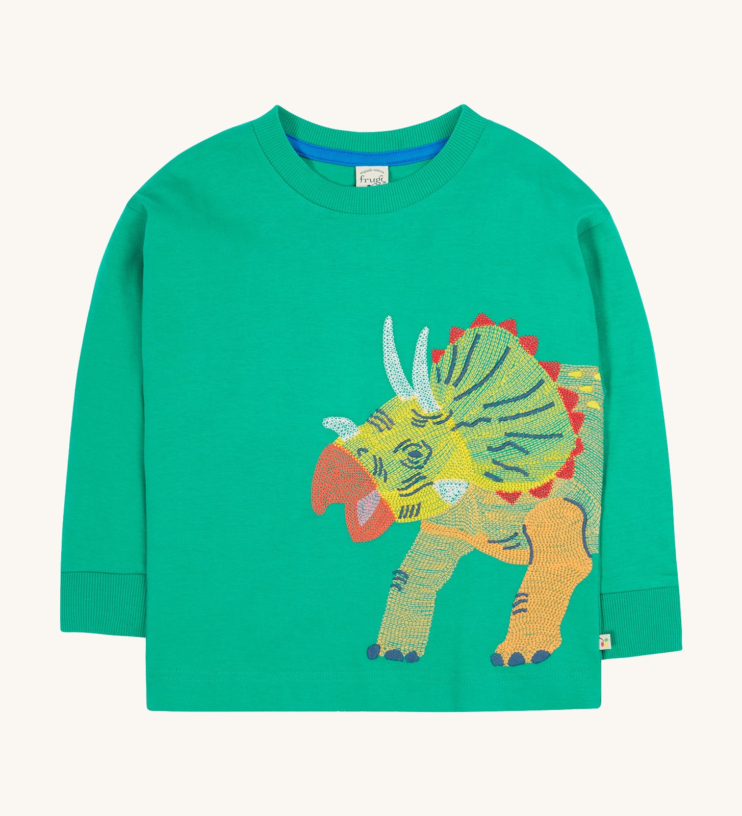 Frugi kids green stop in a green colour with a triceratops design on a cream bakground.