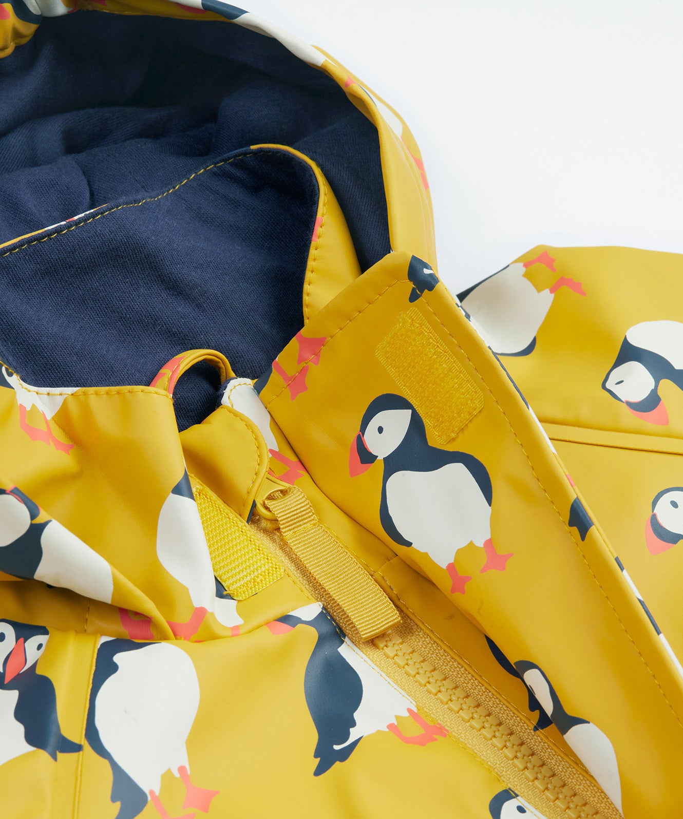 Frugi kids puddle buster jacket yellow with a puffin design hood and zip detail