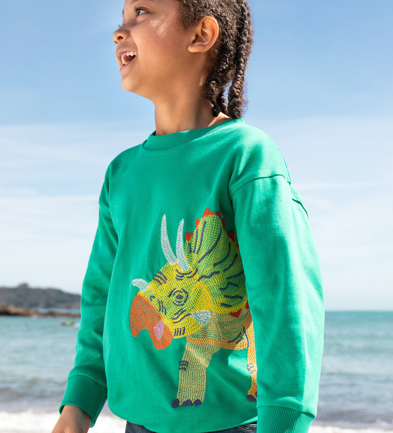 Frugi kids green stop in a green colour with a triceratops design