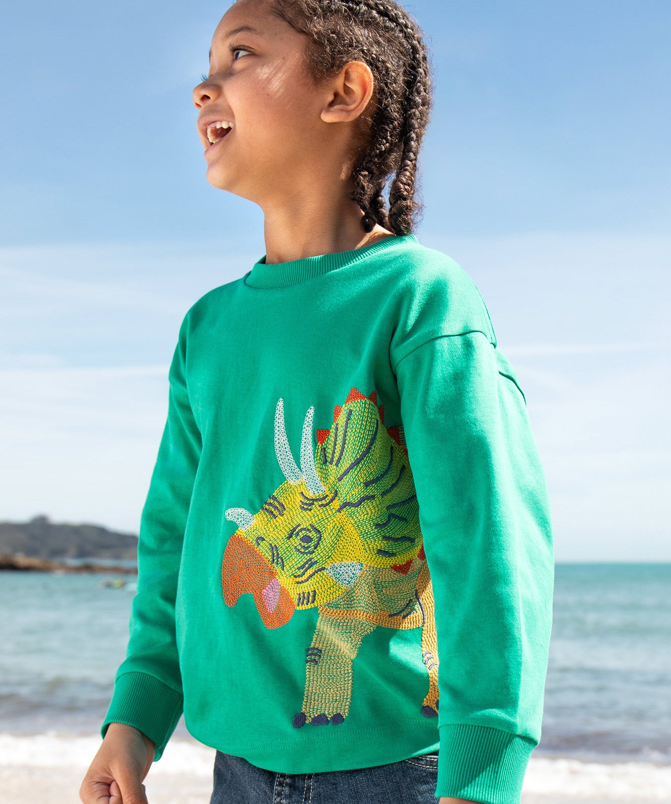 Frugi kids green stop in a green colour with a triceratops design