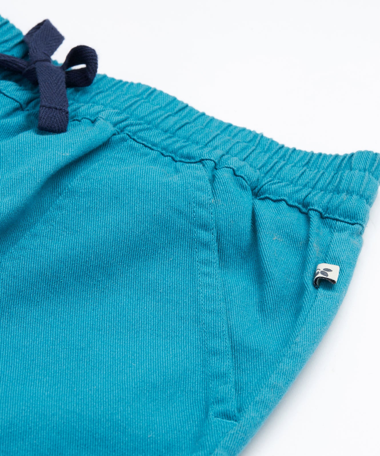 Frugi kids trousers in green, blue, turquoise colour pocket detail