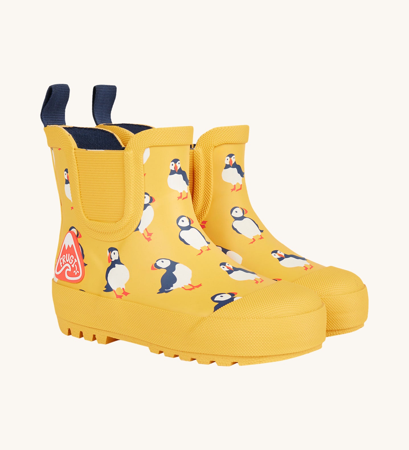 Frugi kids yellow wellington boots puffin design on a cream background.