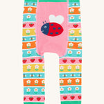 Frugi knitted leggings daisy and ladybird design on a cream background.