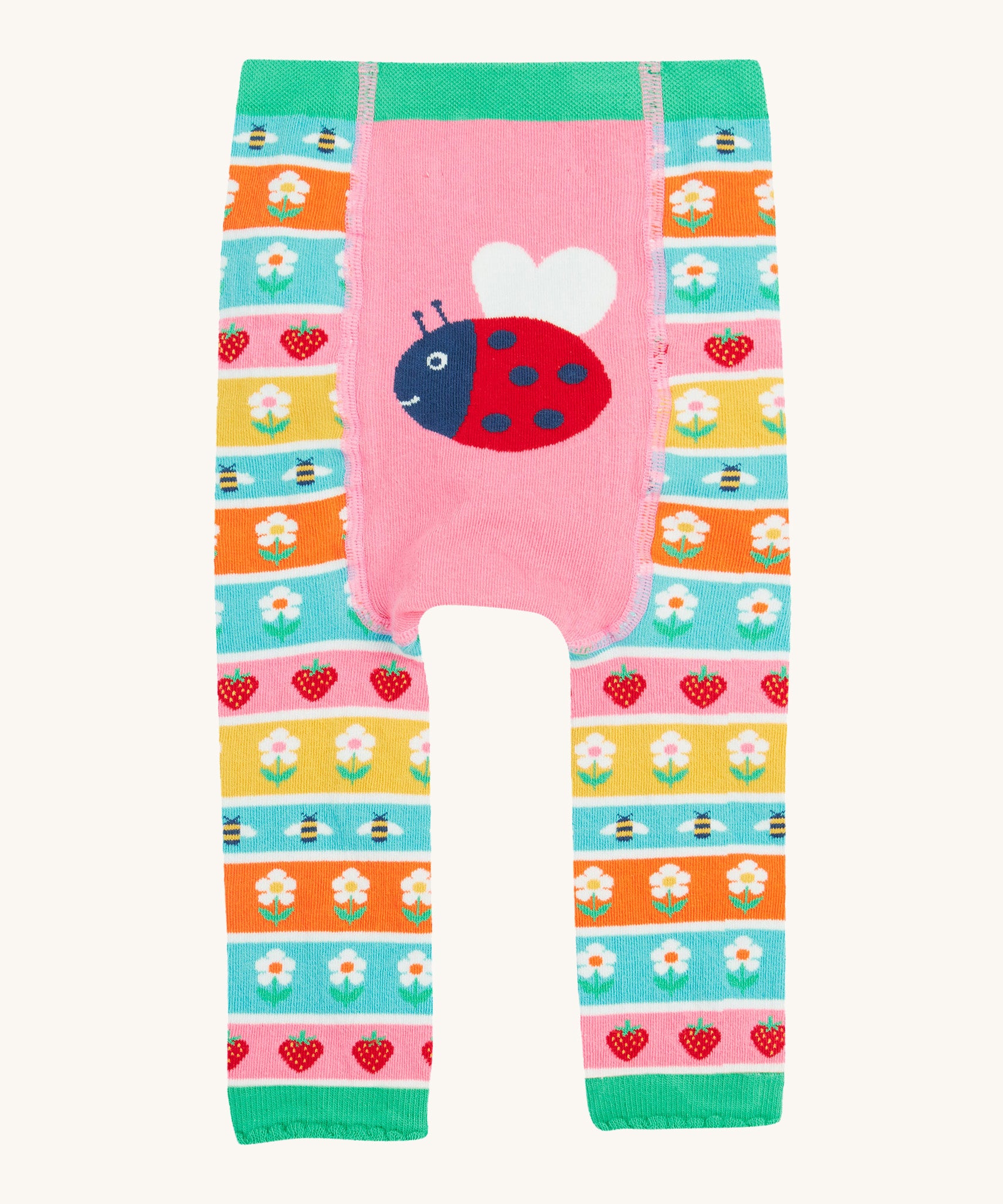 Frugi knitted leggings daisy and ladybird design on a cream background.