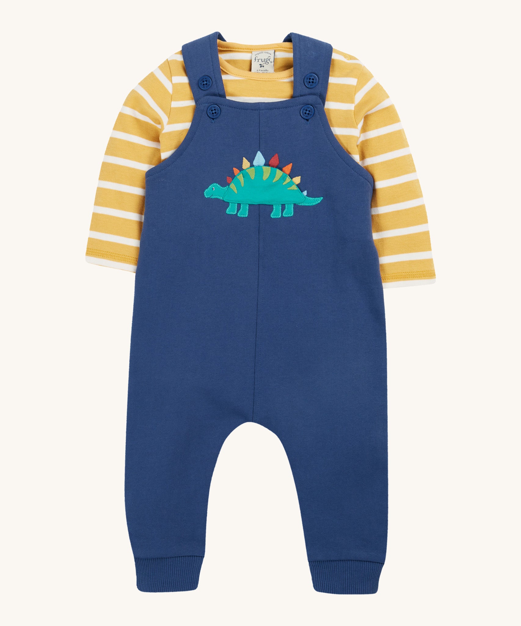 Frugi navy, yellow stripe dungaree outfit dino design on a cream background.