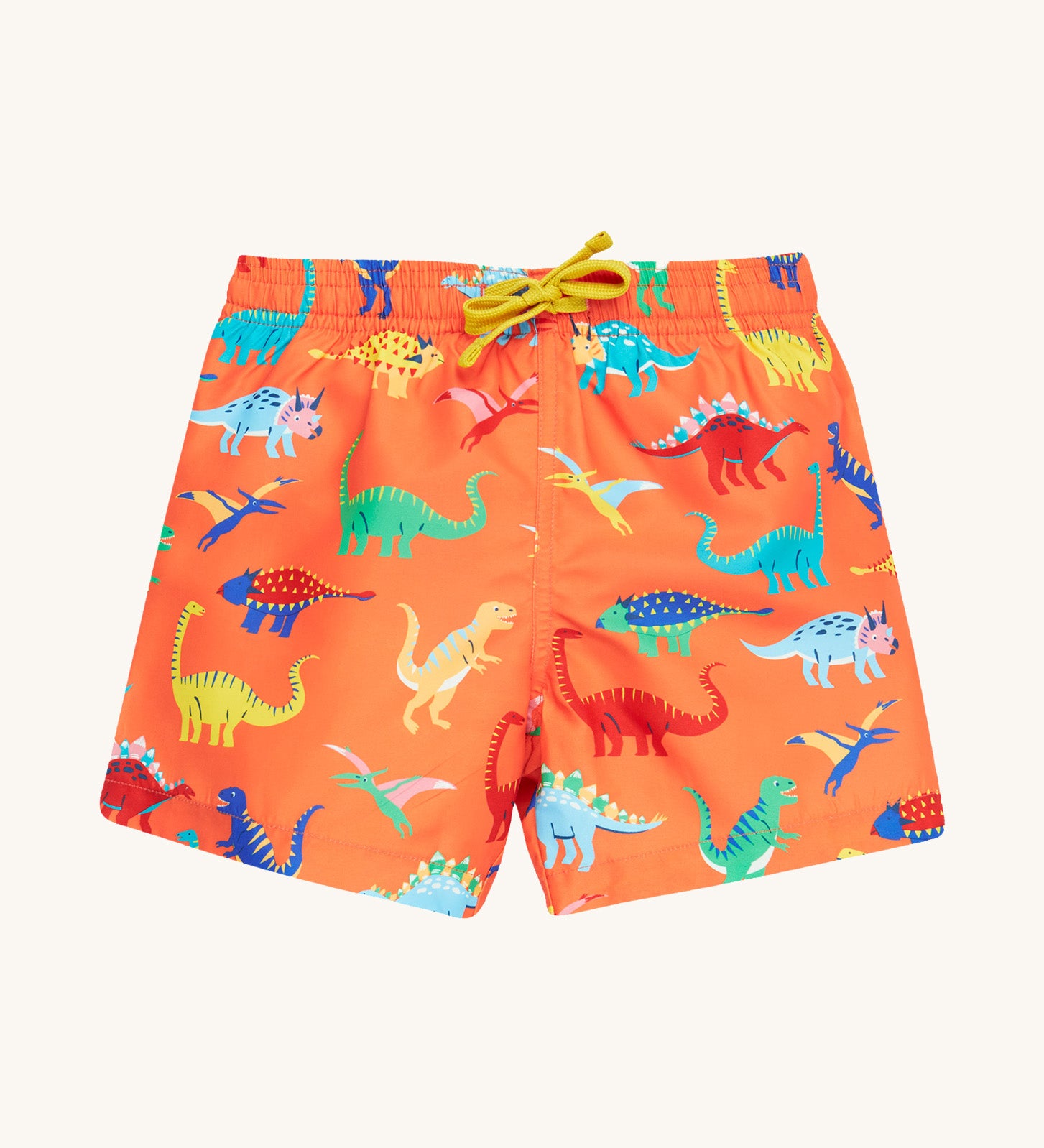 Frugi orange board shorts dino design on a cream background.