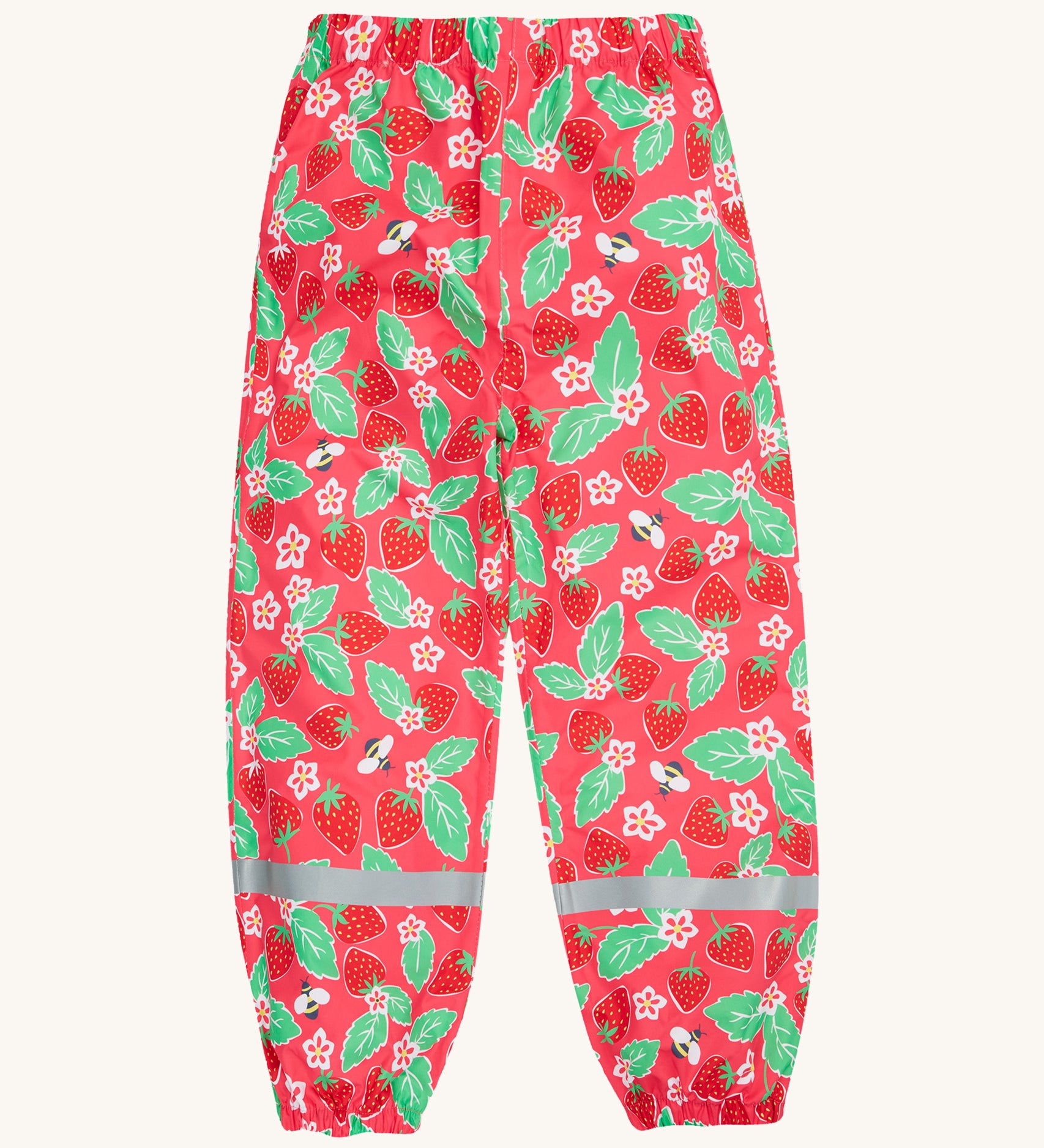 Frugi pink rain shine trousers strawberries design on a cream background.