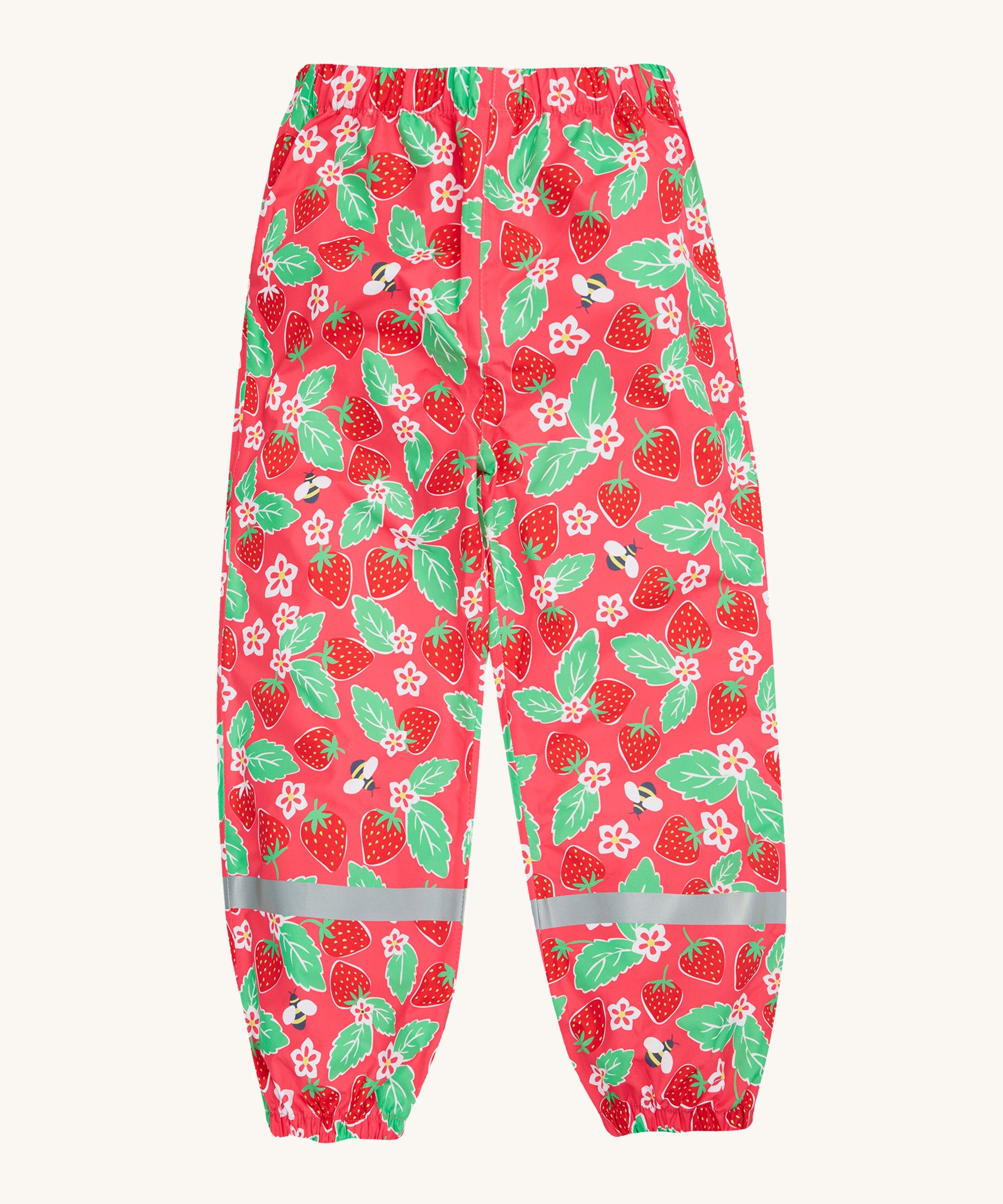 Frugi pink rain shine trousers strawberries design on a cream background.