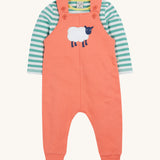 Frugi pink, green stripes dungaree outfit sheep design on a cream background.