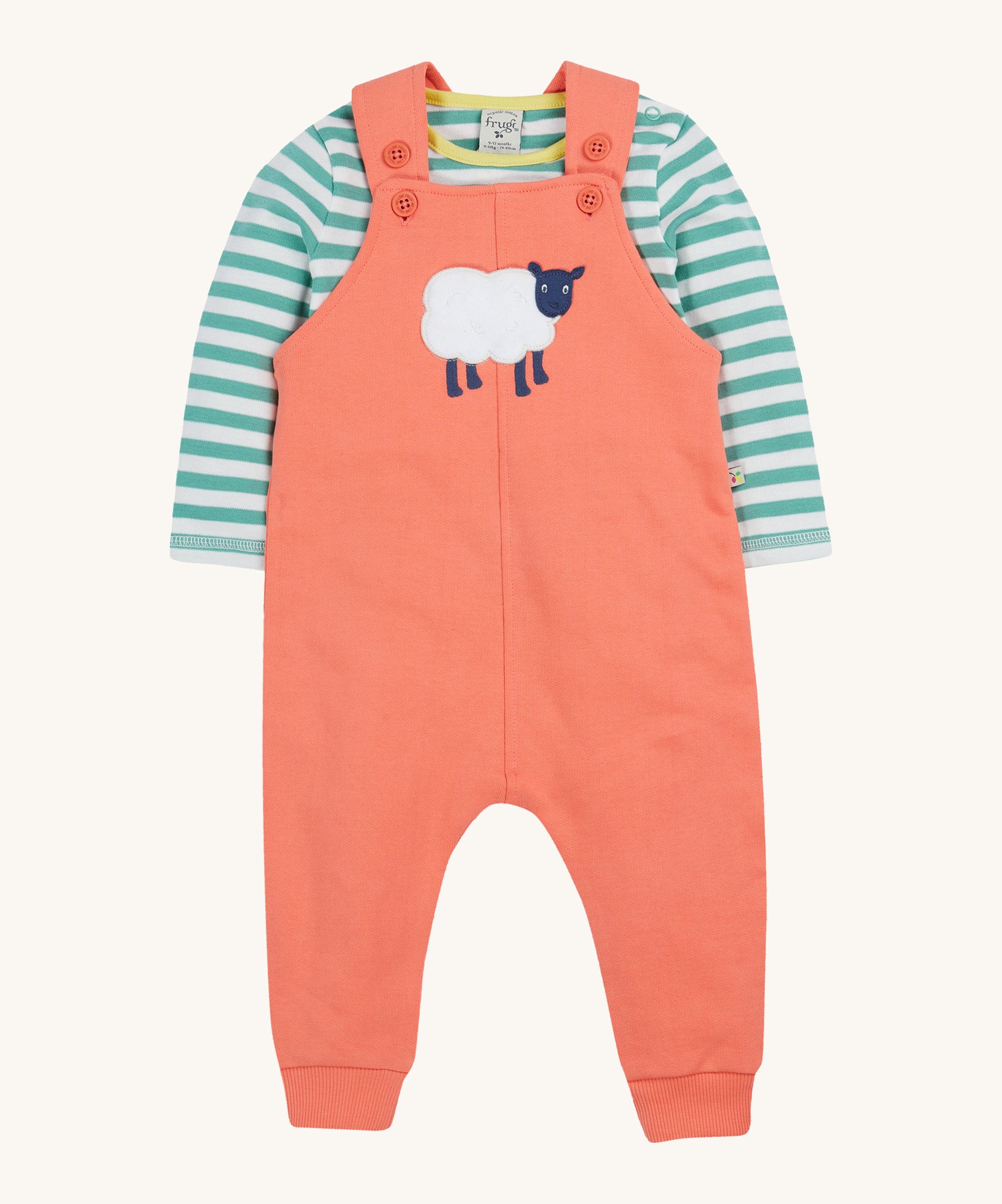 Frugi pink, green stripes dungaree outfit sheep design on a cream background.