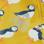 Frugi kids puddle buster jacket yellow with a puffin design print detail