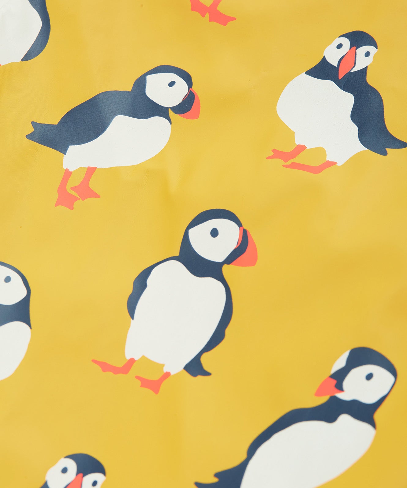 Frugi yellow puddle buster trousers puffin design print detail