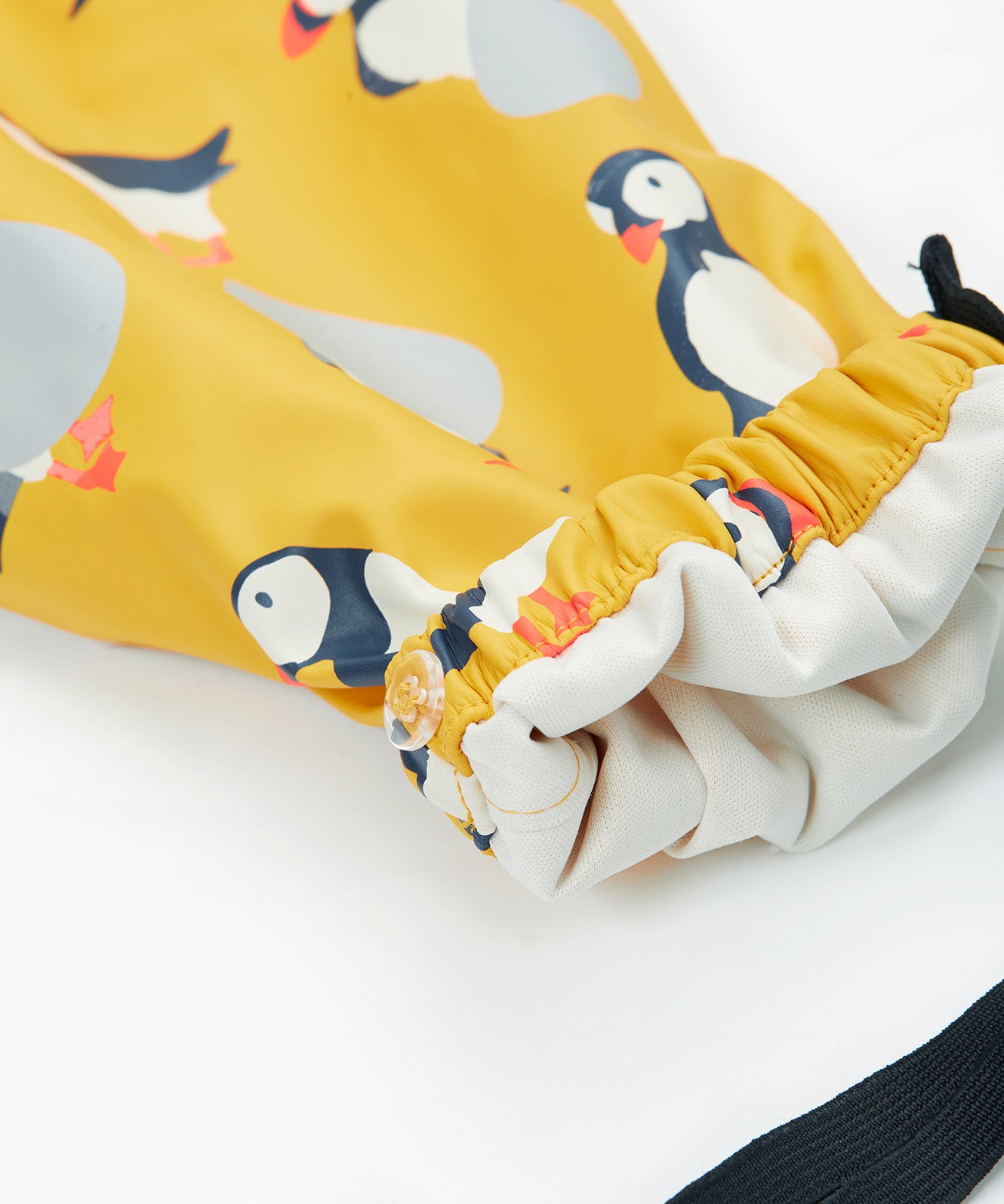 Frugi yellow puddle buster trousers puffin design leg cuff detail