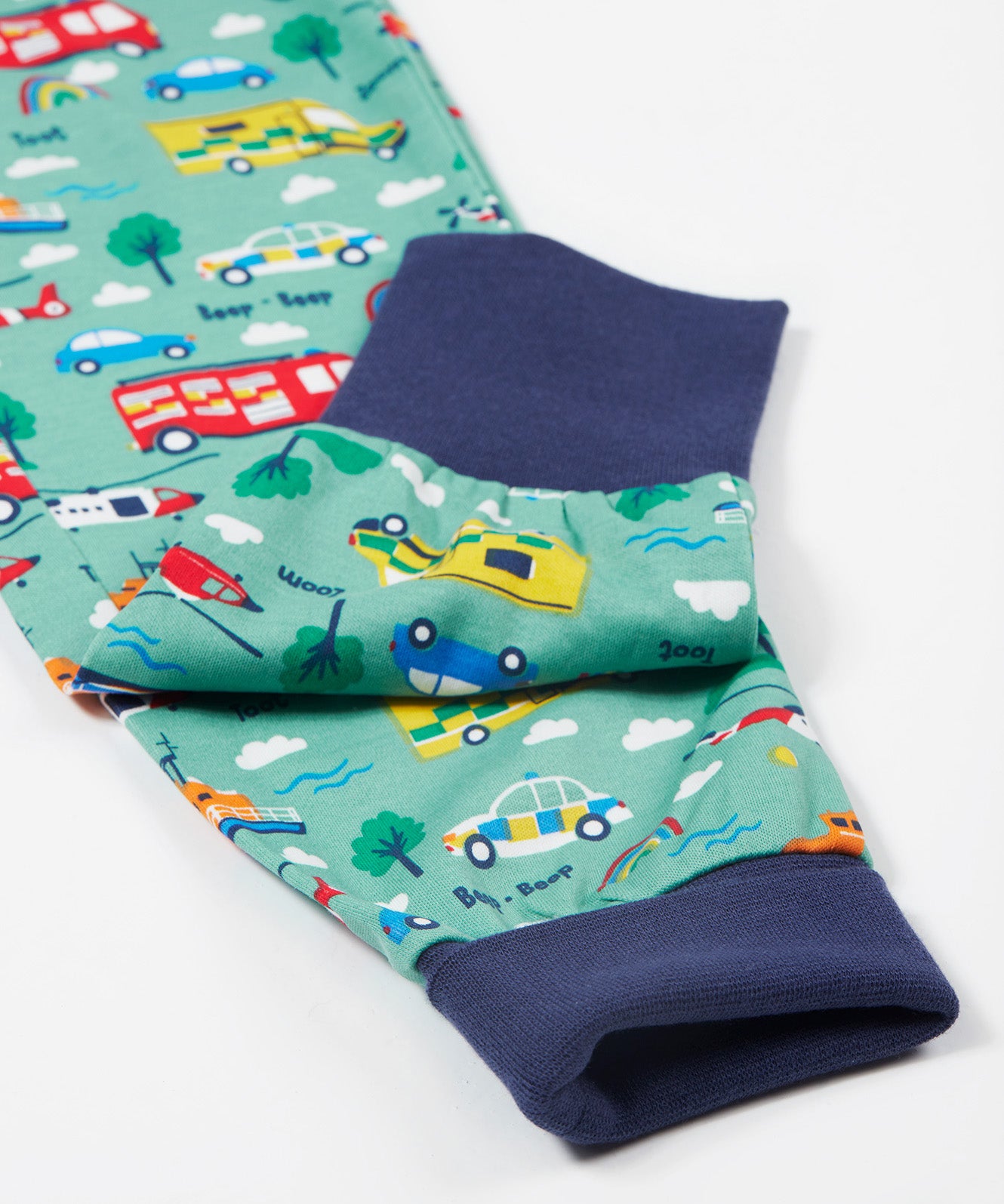 Frugi green pyjama set to the rescue leg cuff detail