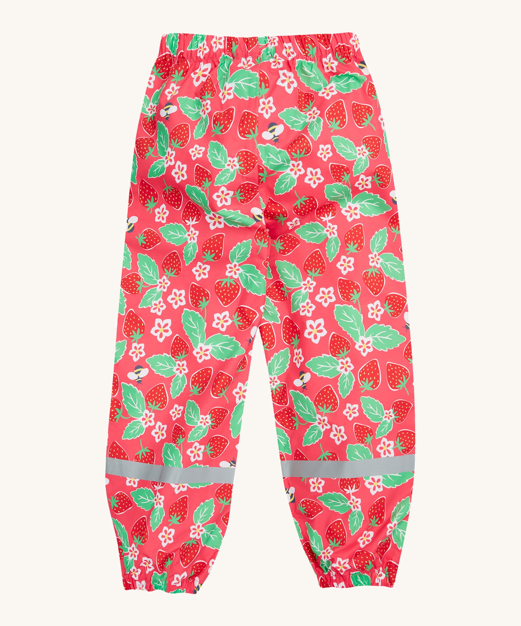 Frugi pink rain shine trousers strawberries design back detail on a cream background.