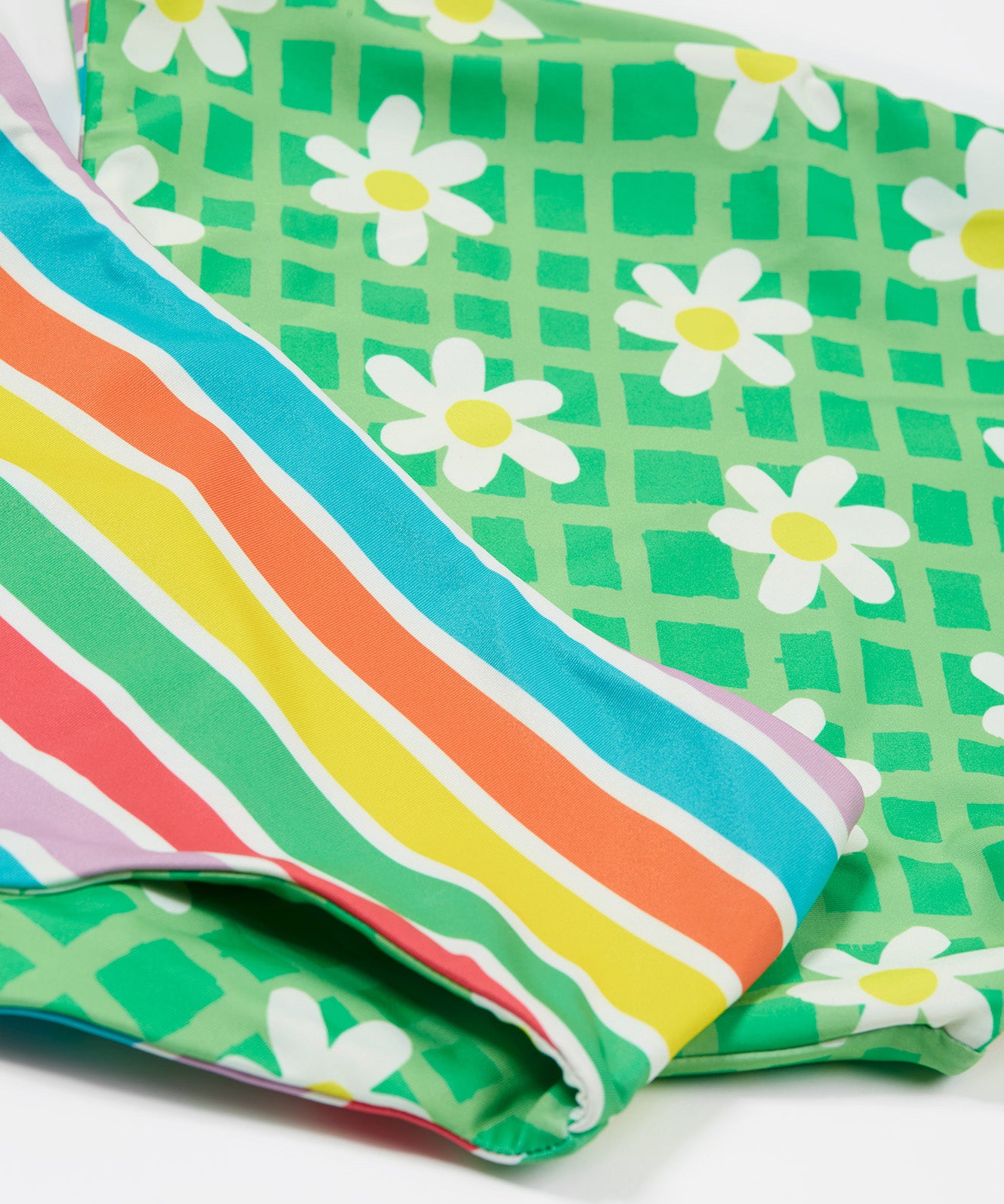 Frugi reversible tankini in a green daisy and summer stripe design detail