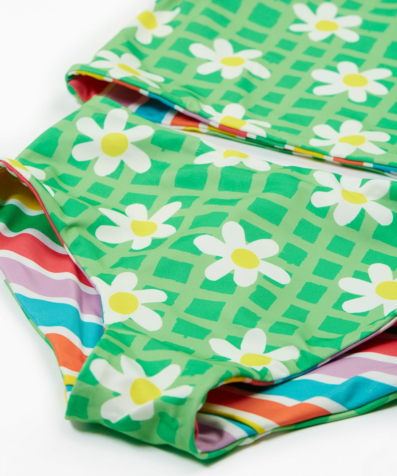 Frugi reversible tankini in a green daisy and summer stripe design daisy print detail