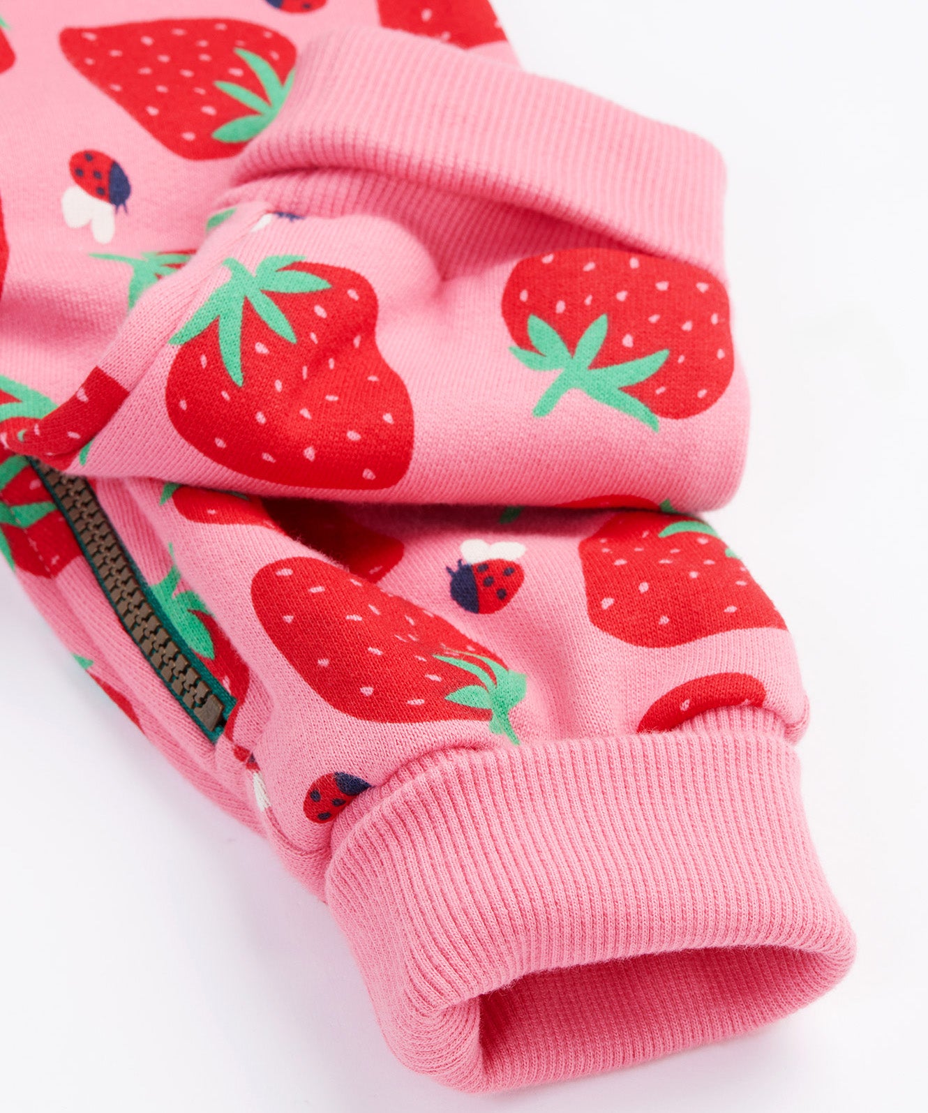 Frugi kids snuggle suit in strawberry design leg cuff detail