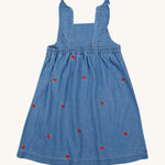 Frugi blue denim dress strawberry design back detail on a cream background.