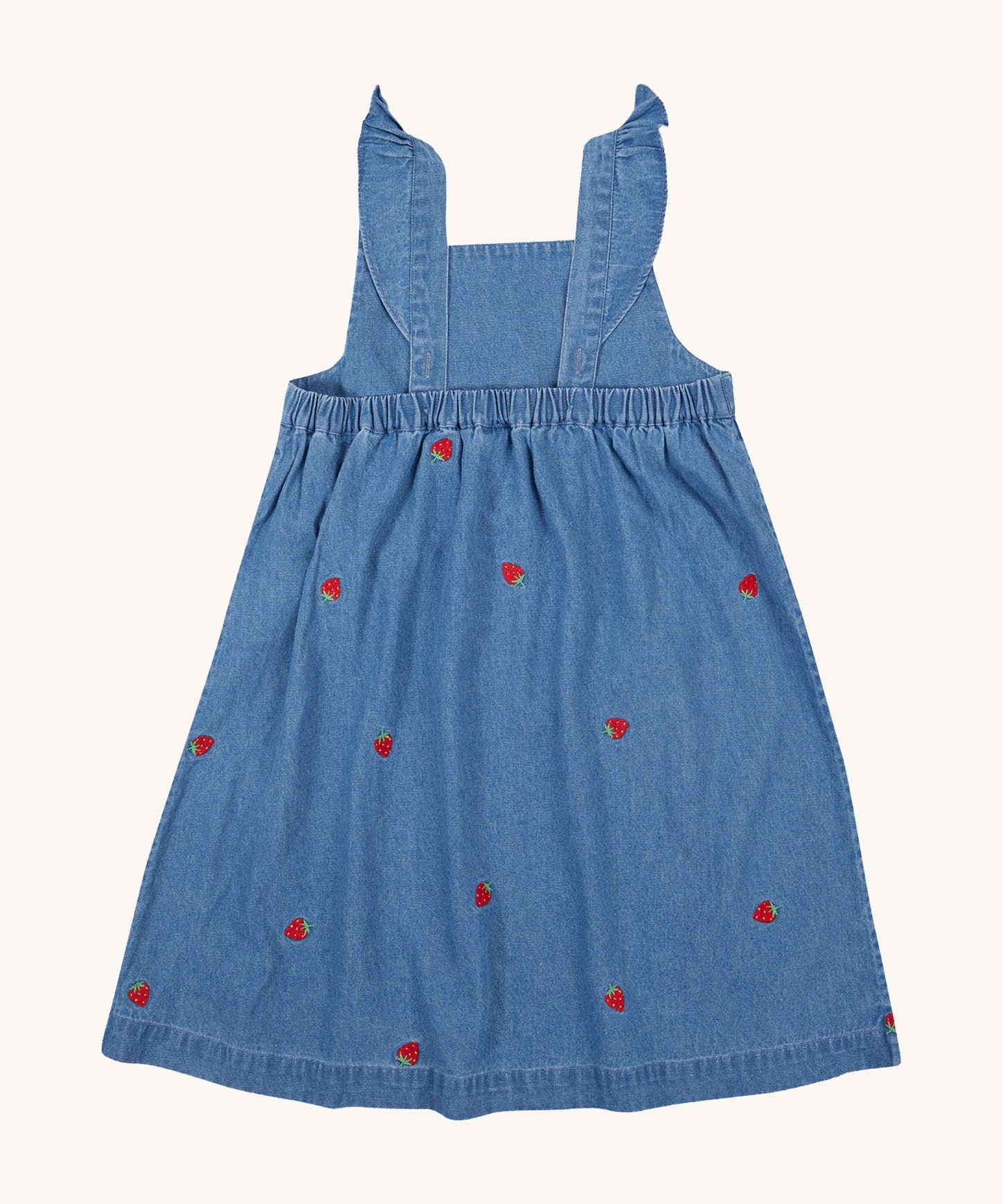 Frugi blue denim dress strawberry design back detail on a cream background.