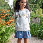 Frugi kids denim skirt with a flower, rainbow and strawberry design