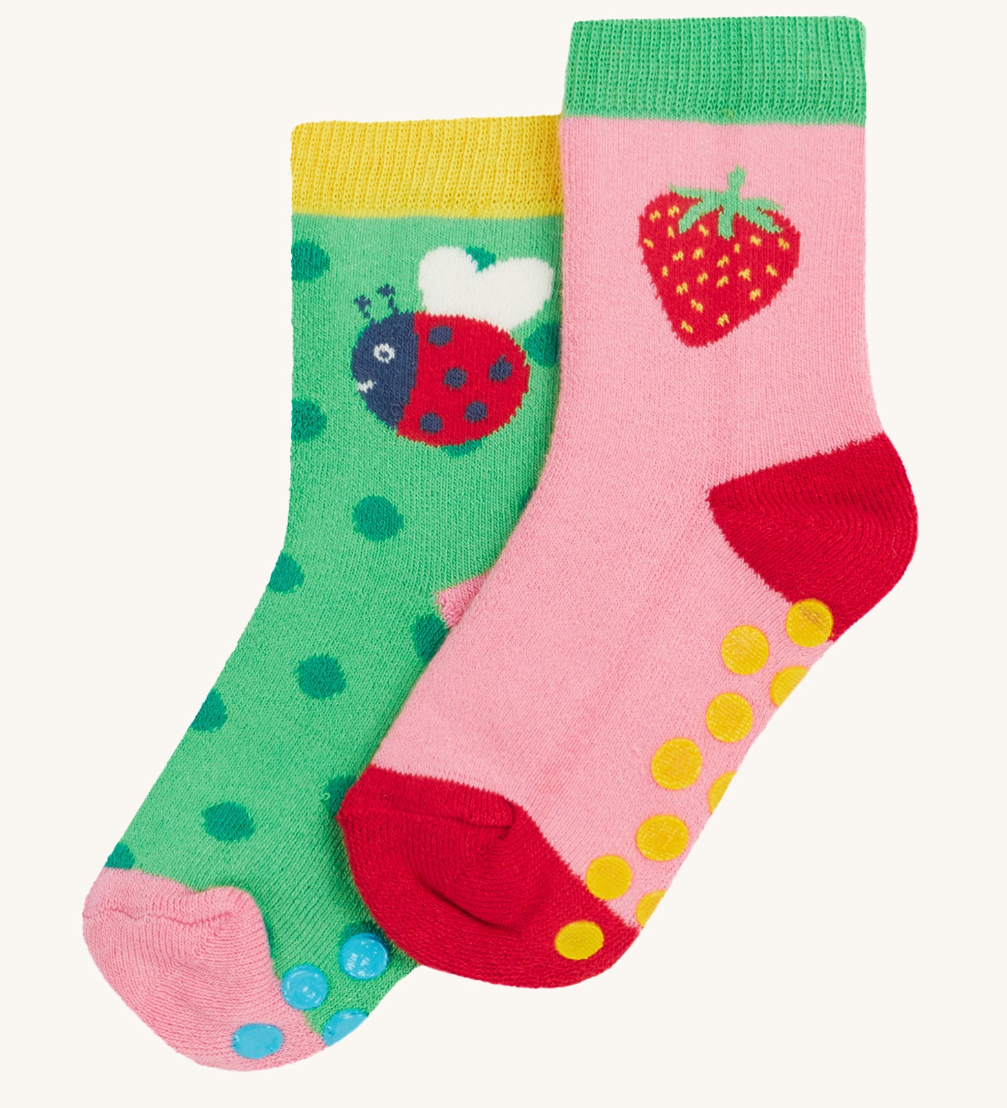 Frugi 2 pack grippy socks strawberry and ladybird design on a cream background