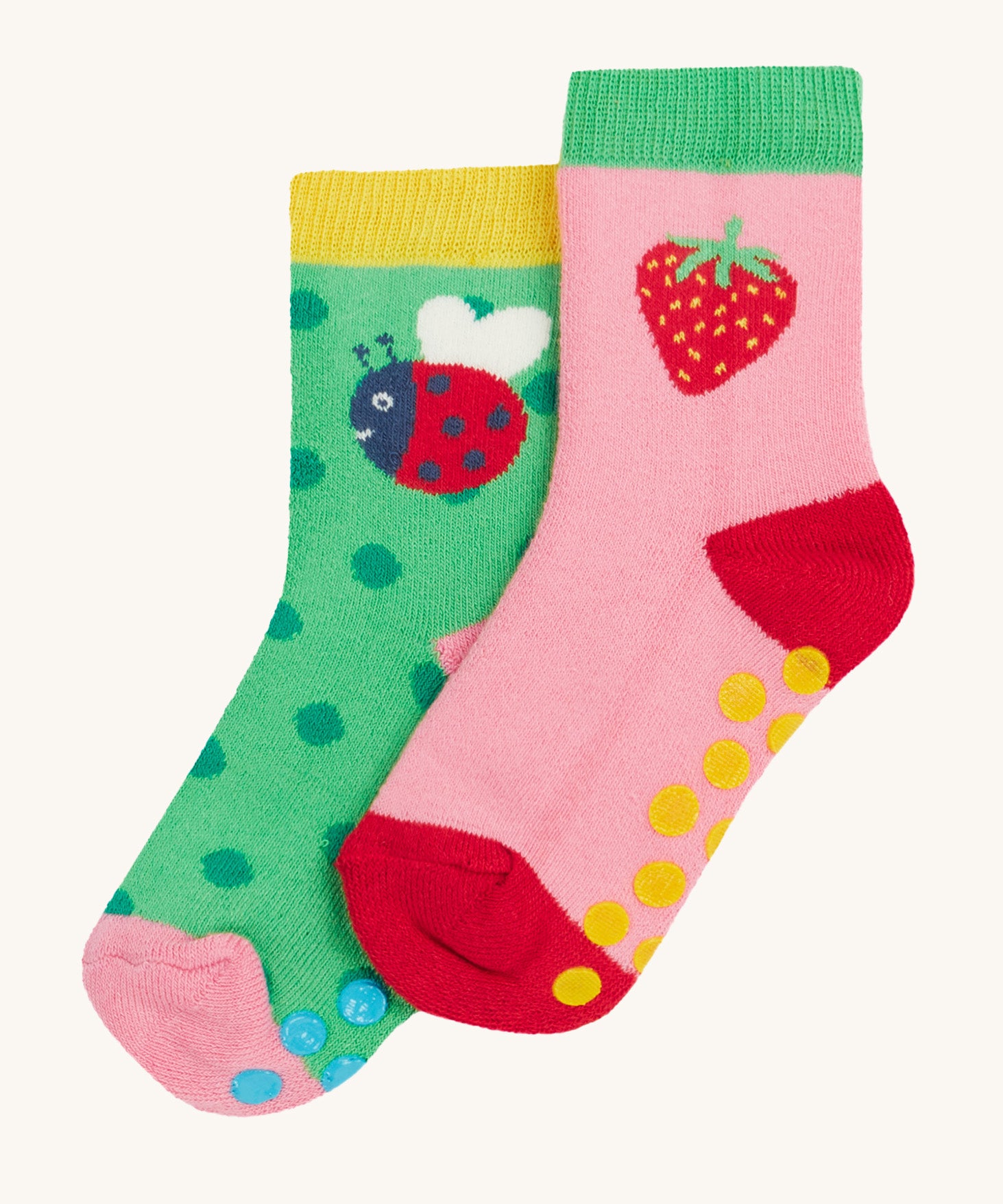 Frugi 2 pack grippy socks strawberry and ladybird design on a cream background