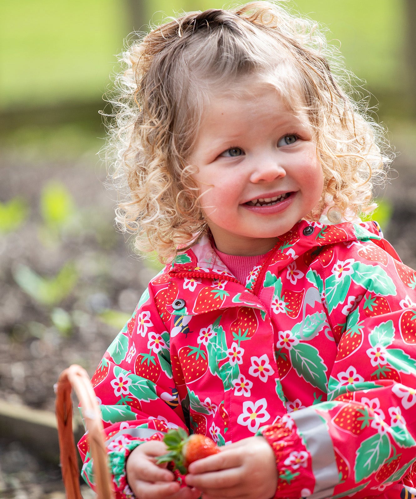 Frugi pink all in one suit strawberry pals design