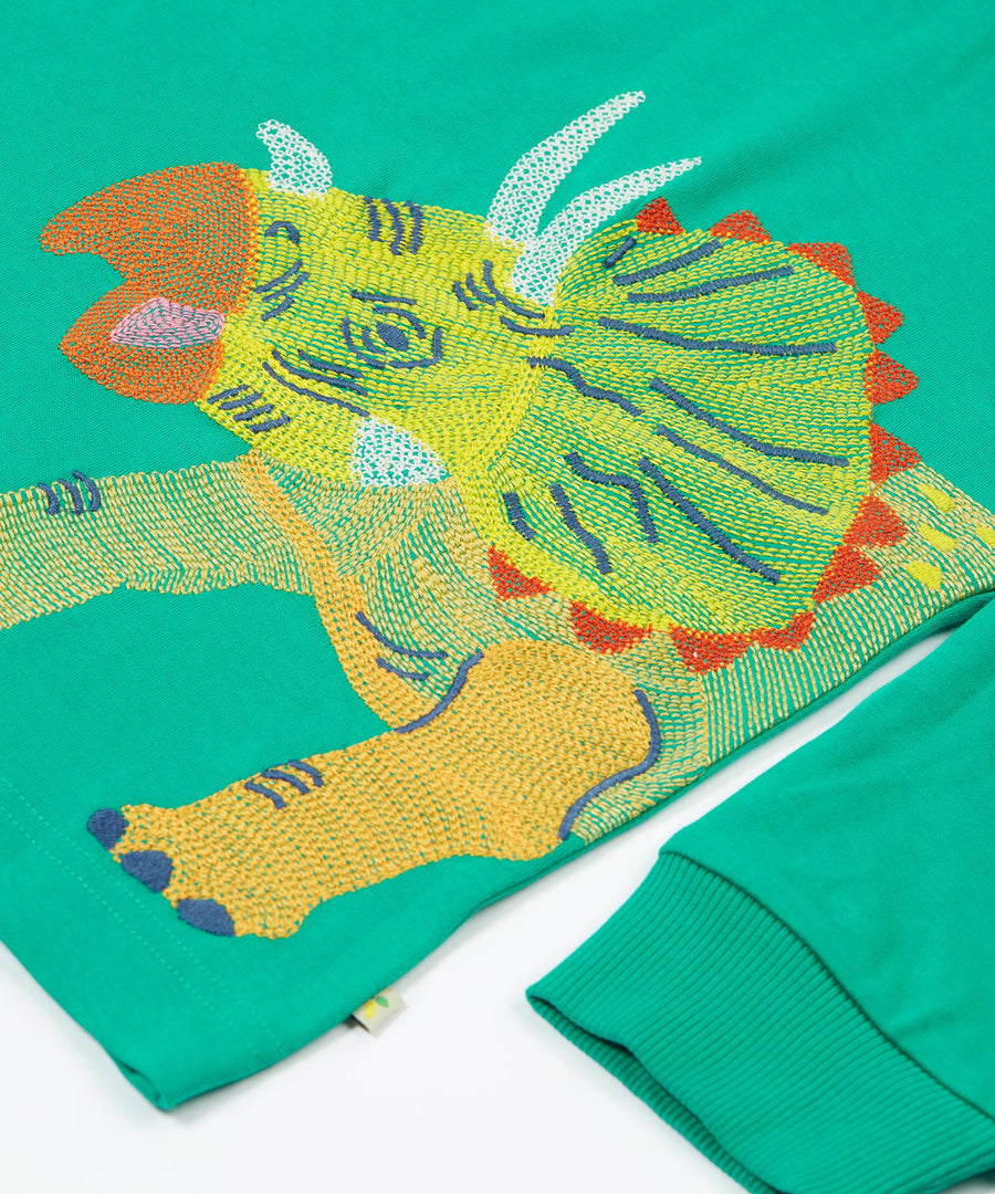 Frugi kids green stop in a green colour with a triceratops design embroidery detail