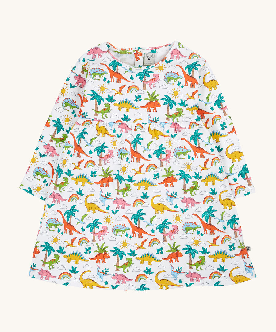 Frugi white dress dinoland design on a cream background.