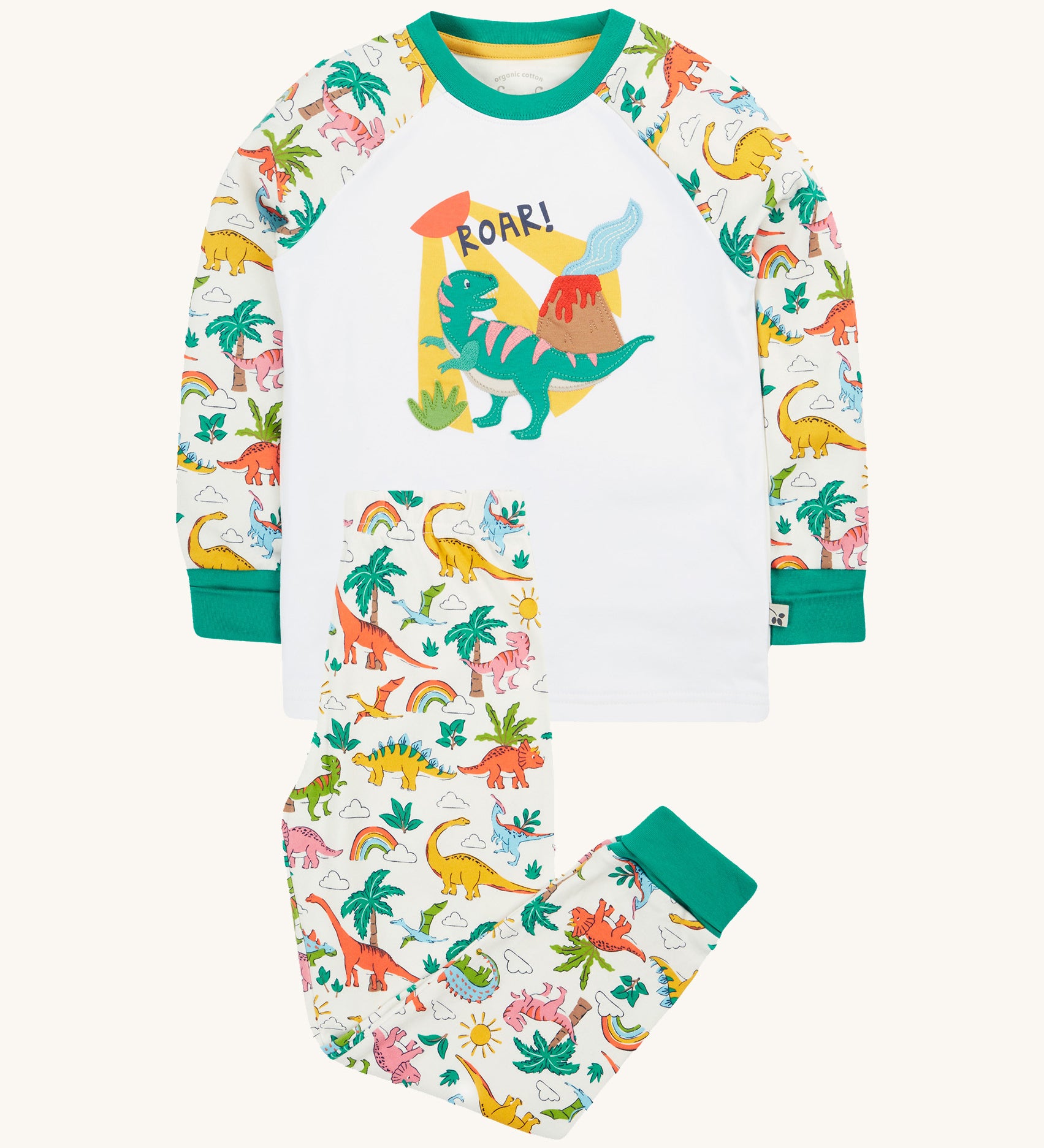 Frugi white pyjama set dinoland design on a cream background.