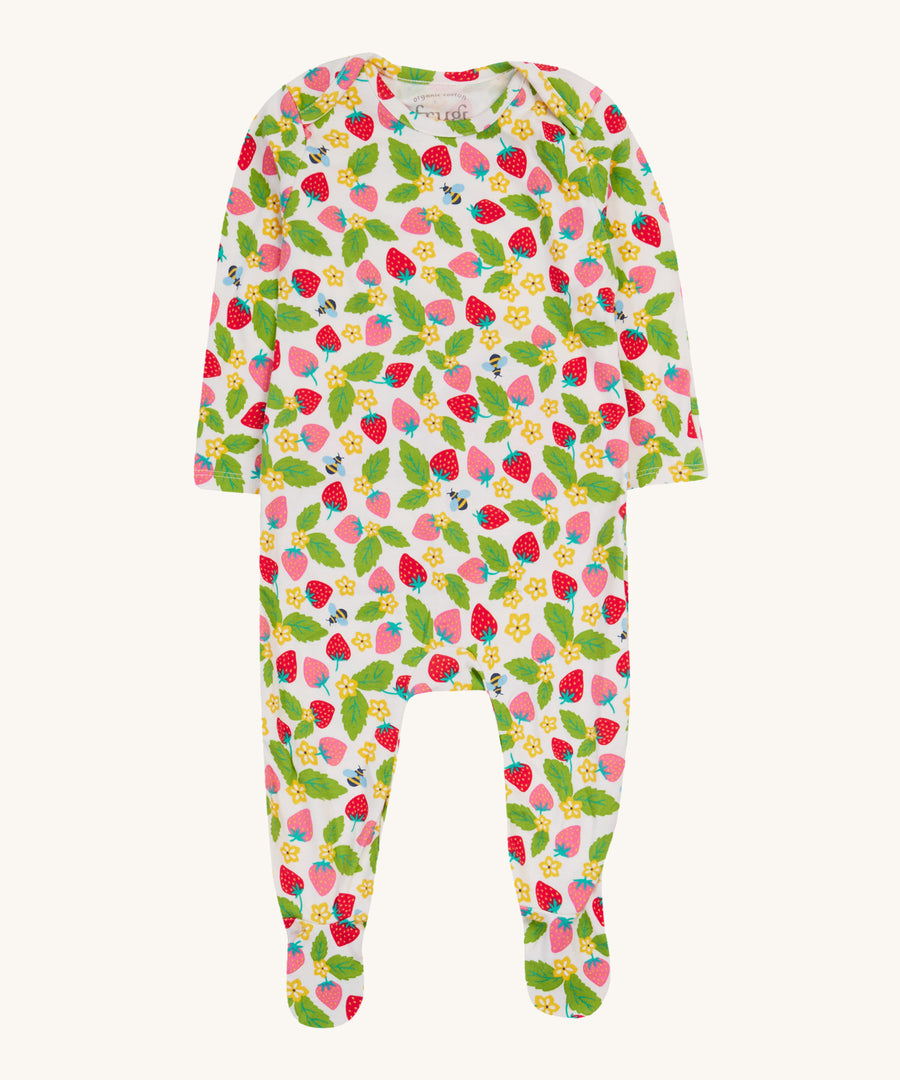 Frugi white dressing baby grow strawberry field design on a cream background.