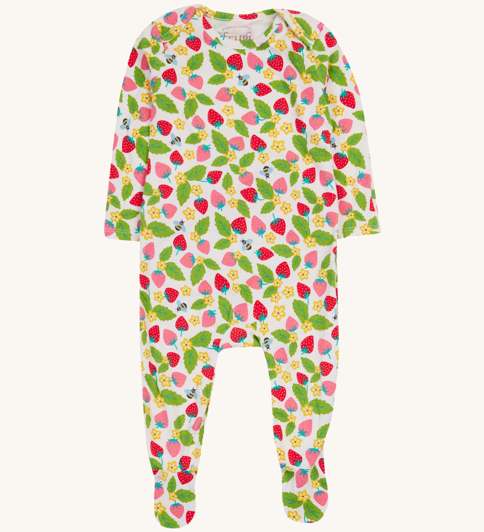 Frugi white dressing baby grow strawberry field design on a cream background.