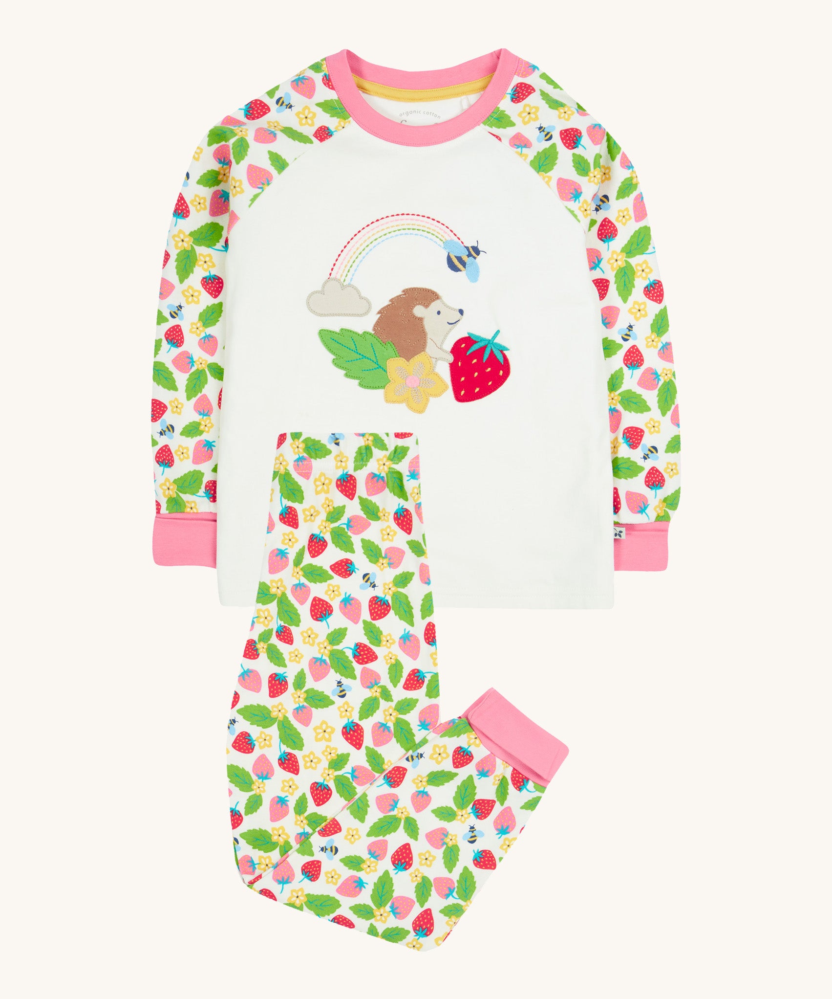 Frugi white pyjama set strawberry field design on a cream background.