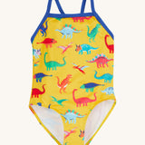 Frugi yellow swim suit dino roar design on a cream background.